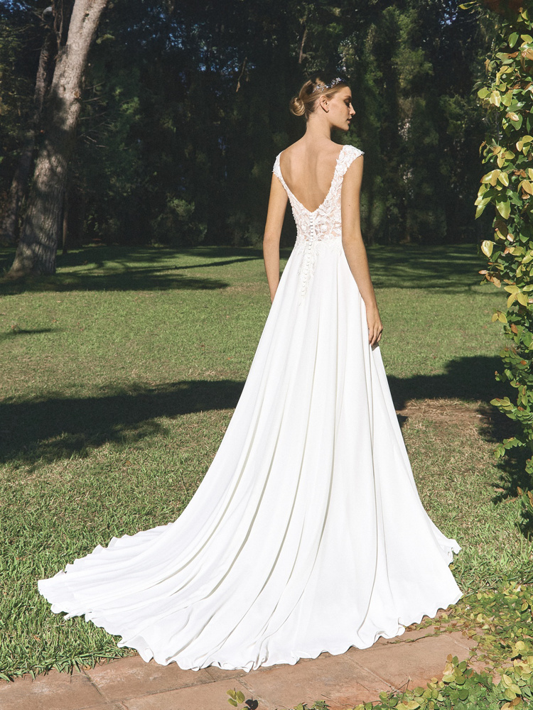 Trouwjurk met lage rug Alguem van White one. Achteraanzicht van de A-lijn jurk met kanten lijfje en lange sleep.