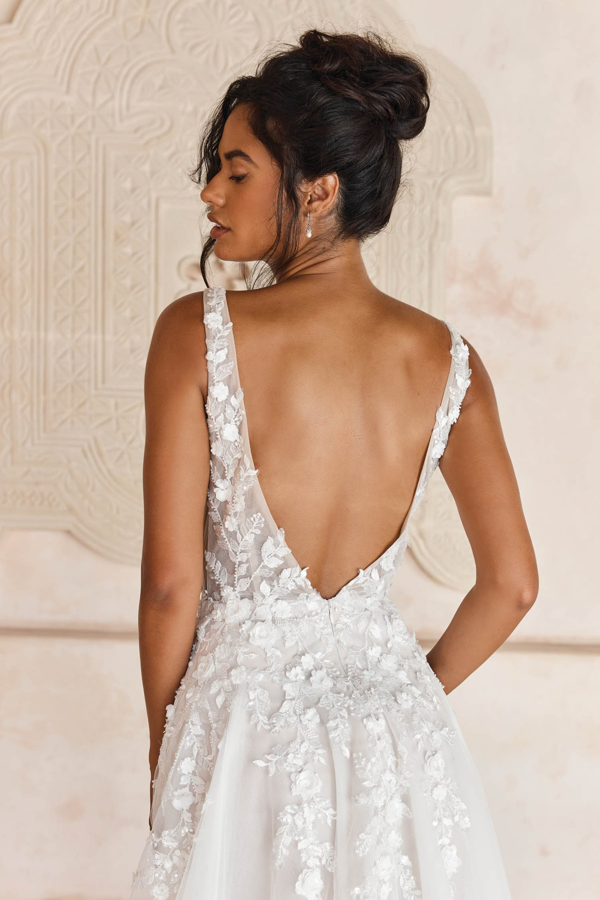 Bruidsjurk Lyndall van Madi Lane met diepe open rug, achteraanzicht. Deze romantische A-lijn jurk heeft 3D kanten details.