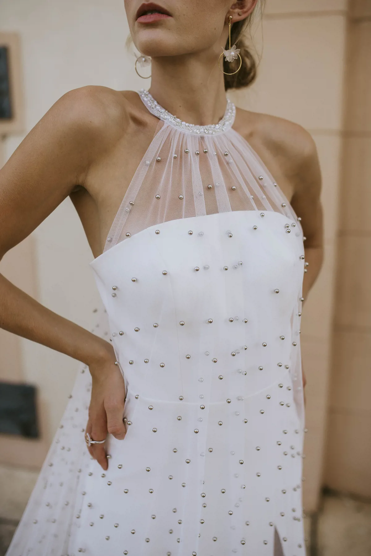 Trouwjurk met parels 8247 van Cizzy Bridal. Close-up van de moderne halter van tule over het strapless lijfje.