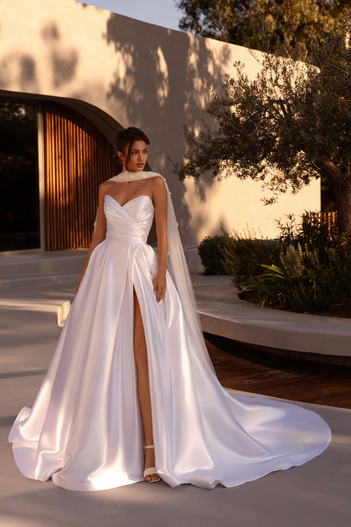 A-lijn trouwjurk met split 1525 van Demetrios. Vooraanzicht van de satijnen jurk met een strapless sweetheart lijfje.