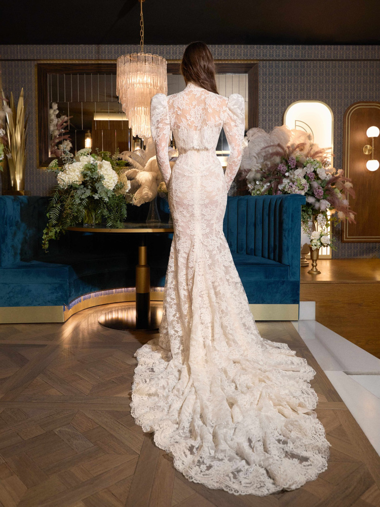 Kanten trouwjurk Velma van Galia Lahav, achteraanzicht. Aangesloten fishtail met hoge hals en lange, gepofte mouwen.