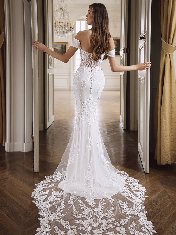 Off-shoulder trouwjurk Fendi van Etoile by Enzoani. Achteraanzicht van de zeemeermin jurk met see-through rug en kanten sleep.