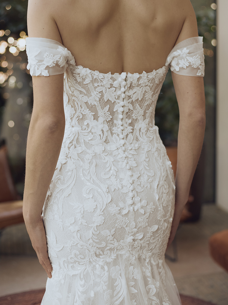 Off-shoulder trouwjurk Georgi van Pronovias met 3D kant en picpac knoopjes. Achteraanzicht van de aangesloten pasvorm.