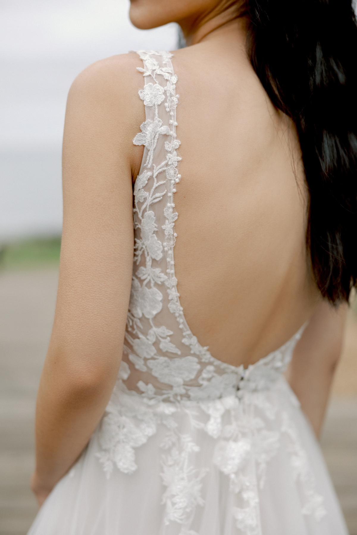 Trouwjurk met lage rug 11418 van Adore. Close-up achteraanzicht van het kanten lijfje met see-through details.