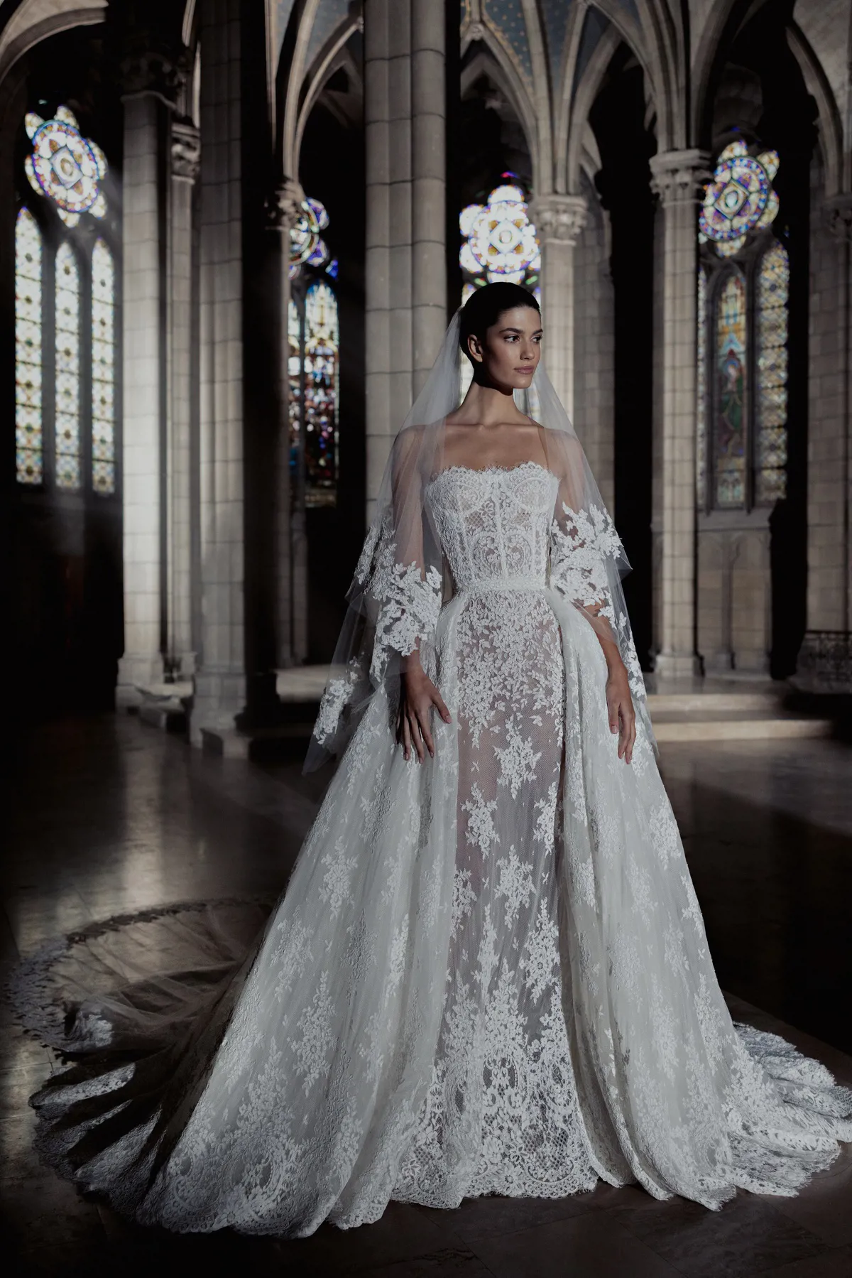 Trouwjurk met kant Holly van Zuhair Murad, vooraanzicht A-lijn met see-through overrok, exclusief bij Bruidshuis Diana.