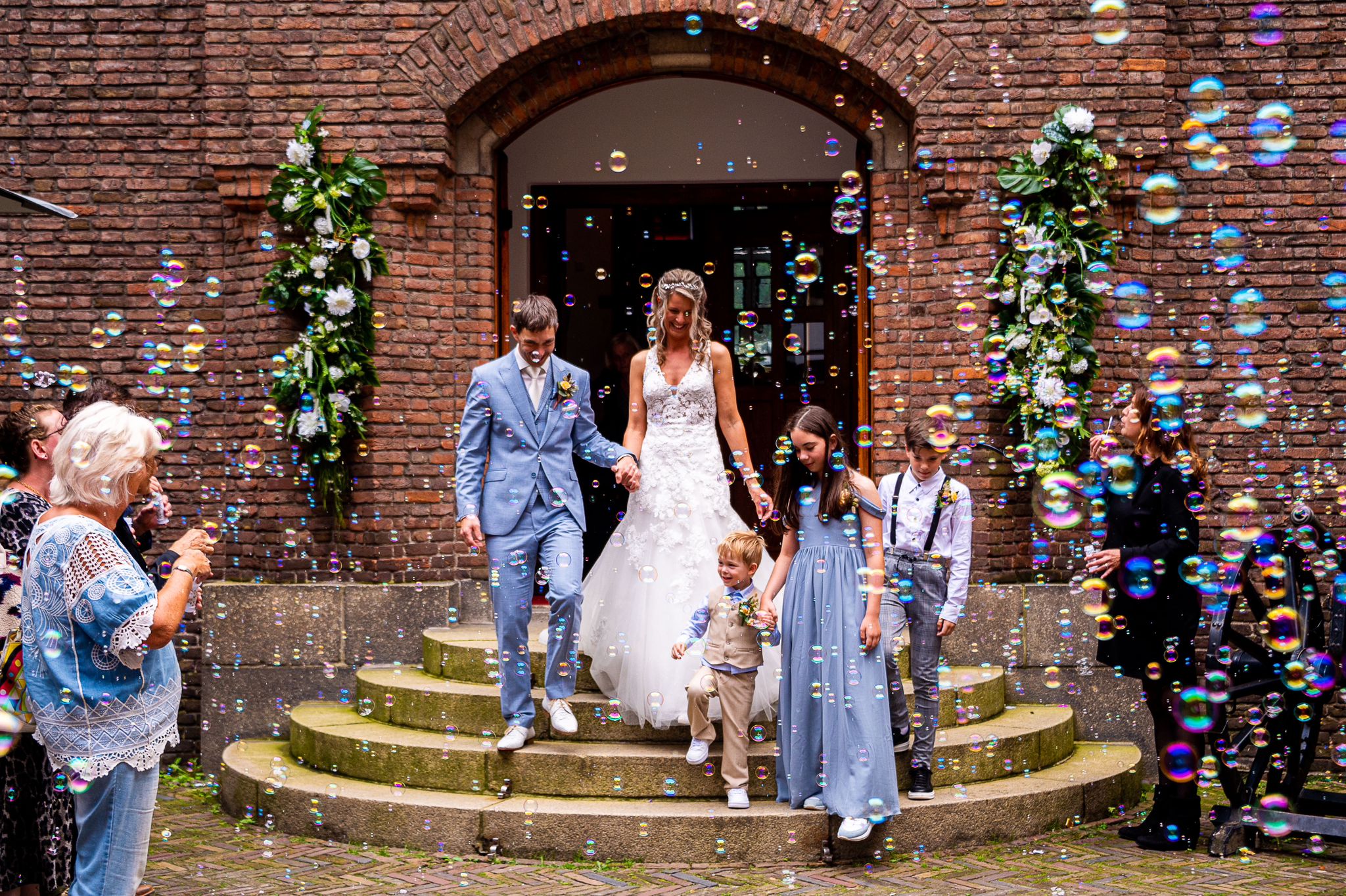 marlyn in haar trouwjurk komen buiten