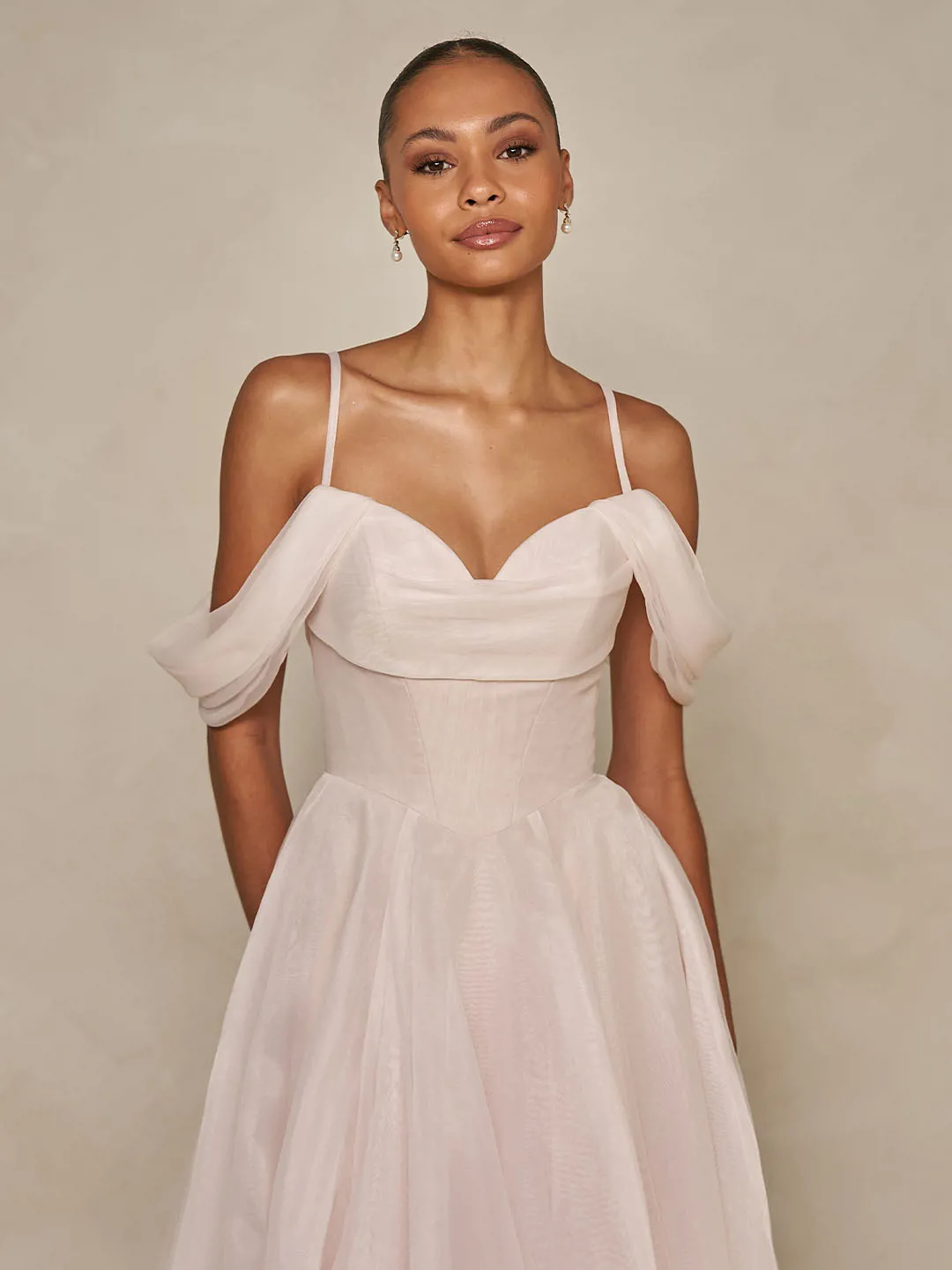 Blush off-shoulder trouwjurk Wisteria van Ines di Santo. Vooraanzicht van het gedrapeerde korsetlijfje met schouderbandjes.