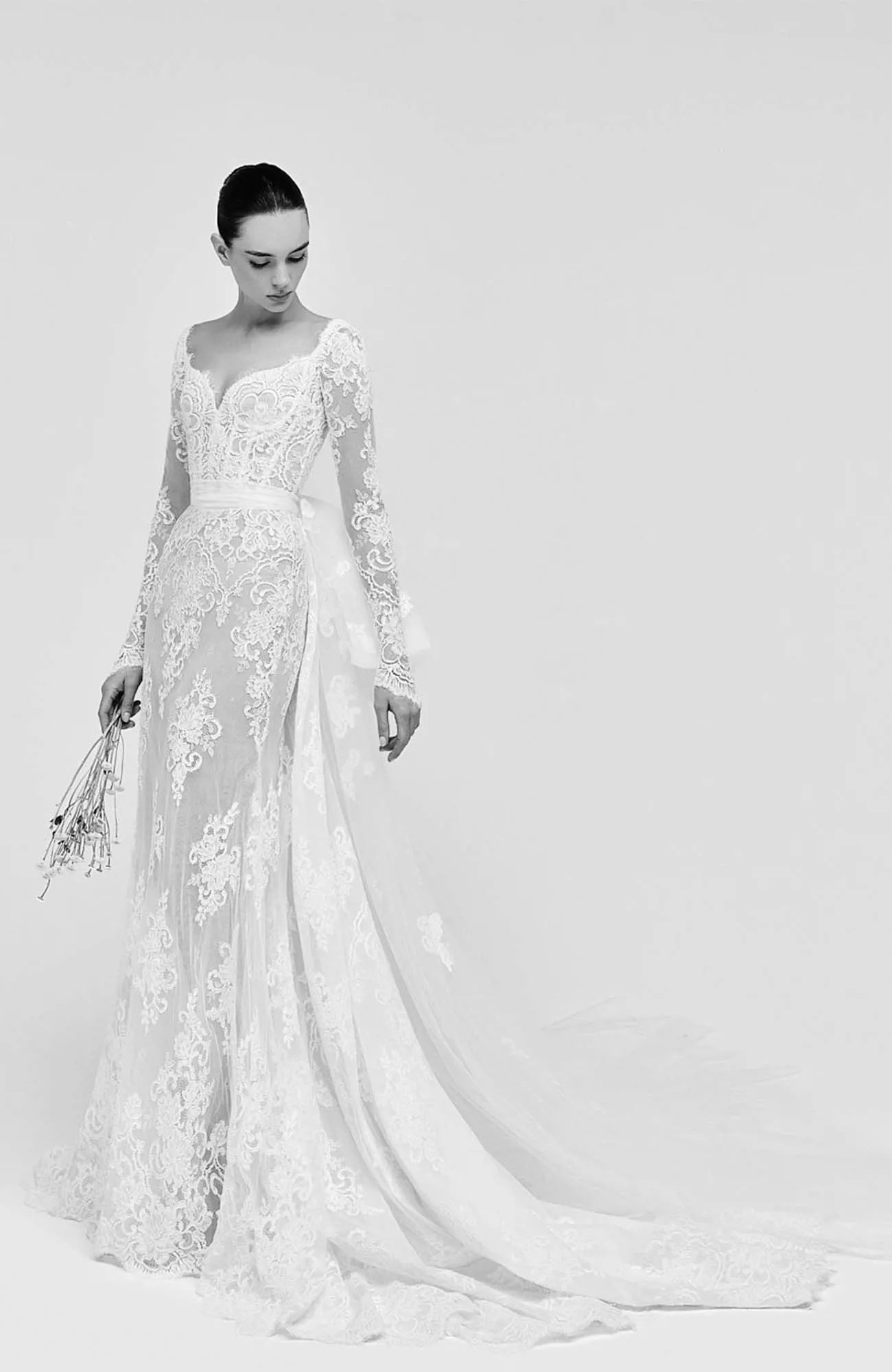 Zuhair Murad Mariage Spring 2026 Look 3 back view of strapless lace wedding dress with oversized satin bow and full overskirt