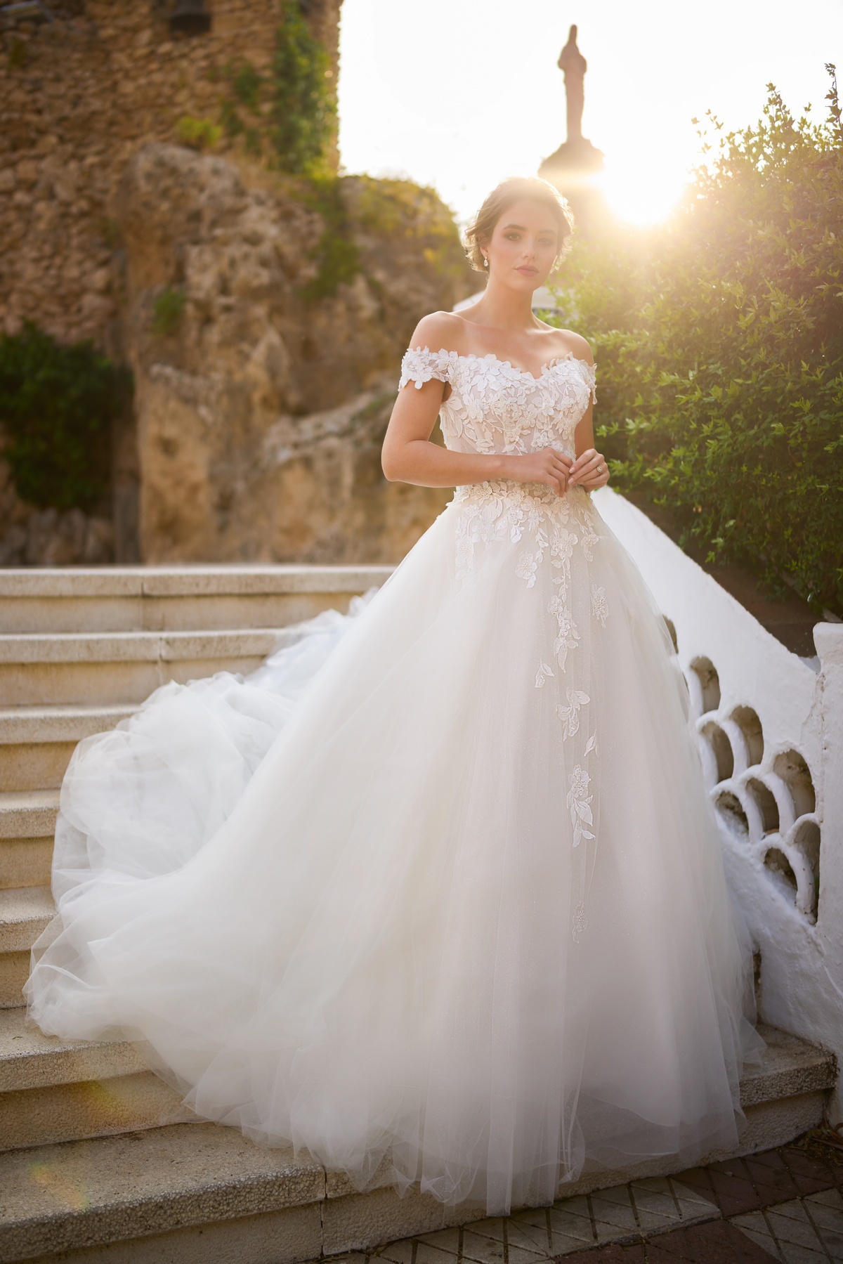 Off-shoulder prinsessenjurk 26206 van Tres chic, vooraanzicht. Romantische trouwjurk met kanten details en volle tule rok.