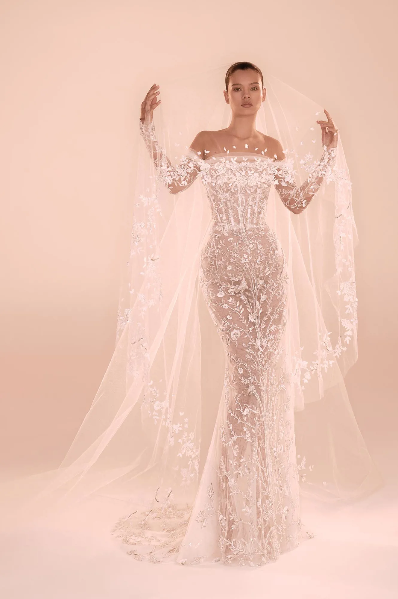 Zuhair Murad Mariage Fall 2026 Look 7 side view of off-shoulder lace wedding dress with detachable overskirt and long train